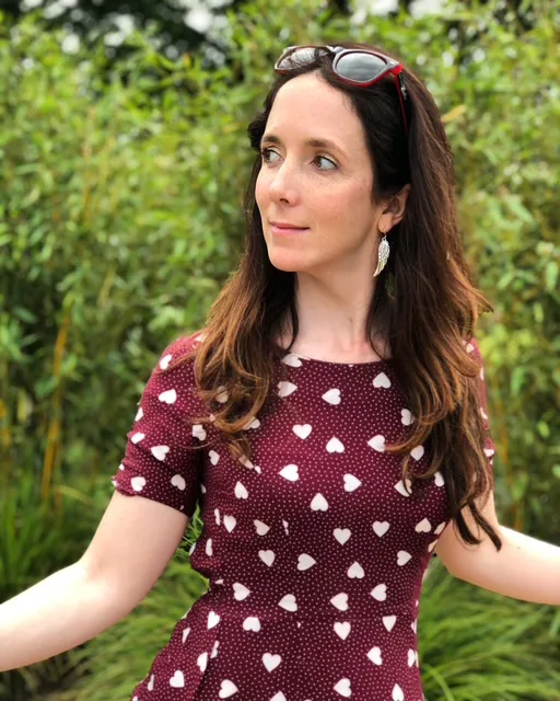 Daisy Smith wearing a dark red dress with hearts